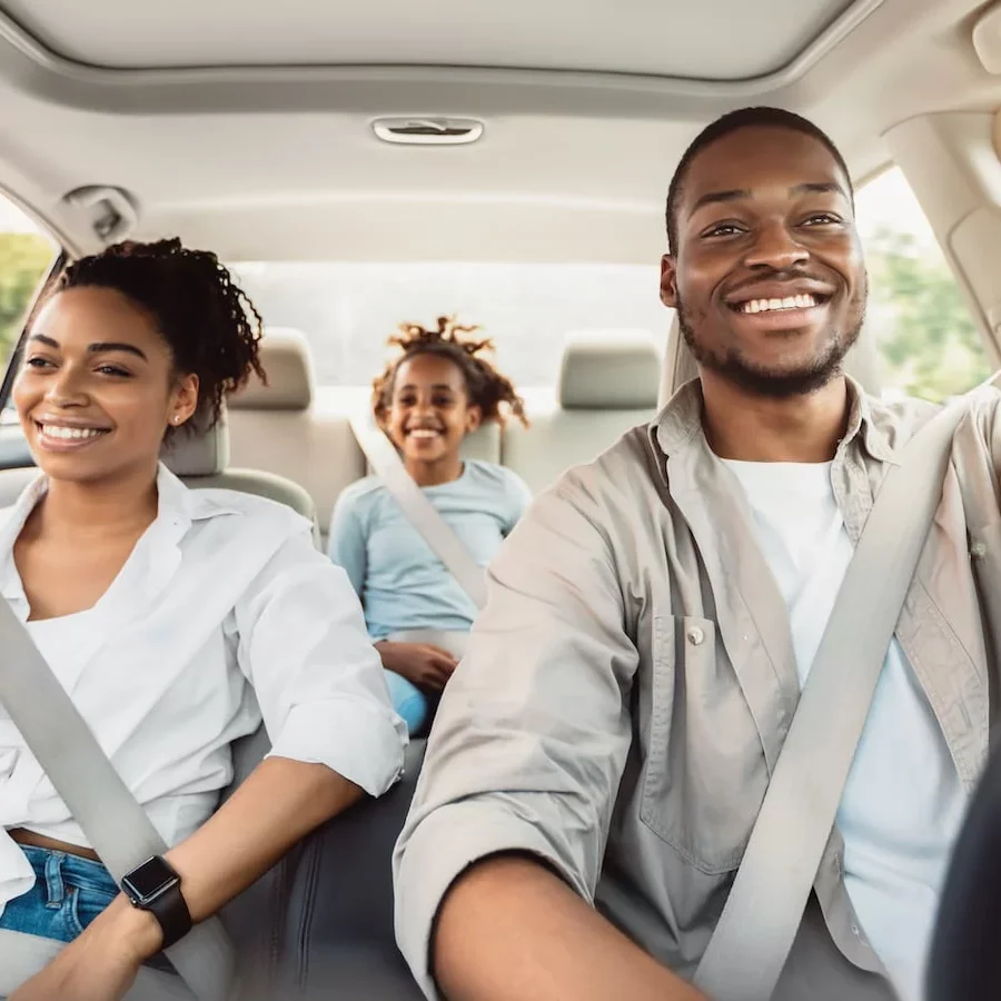 family in car smiling